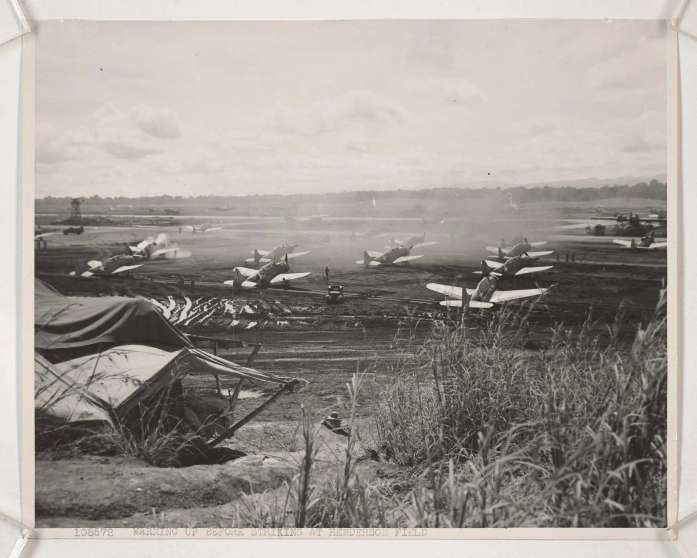 Guadalcanal, December 10, 1942. Marine SBD Squadron warms up before strike at Henderson Field during December 1942.